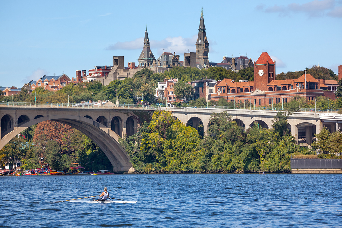 Rowing Potomac River Key Bridge Georgetown University Washington DC from Roosevelt Island.  Completed in 1923 this is the oldest bridge in Washington DC.